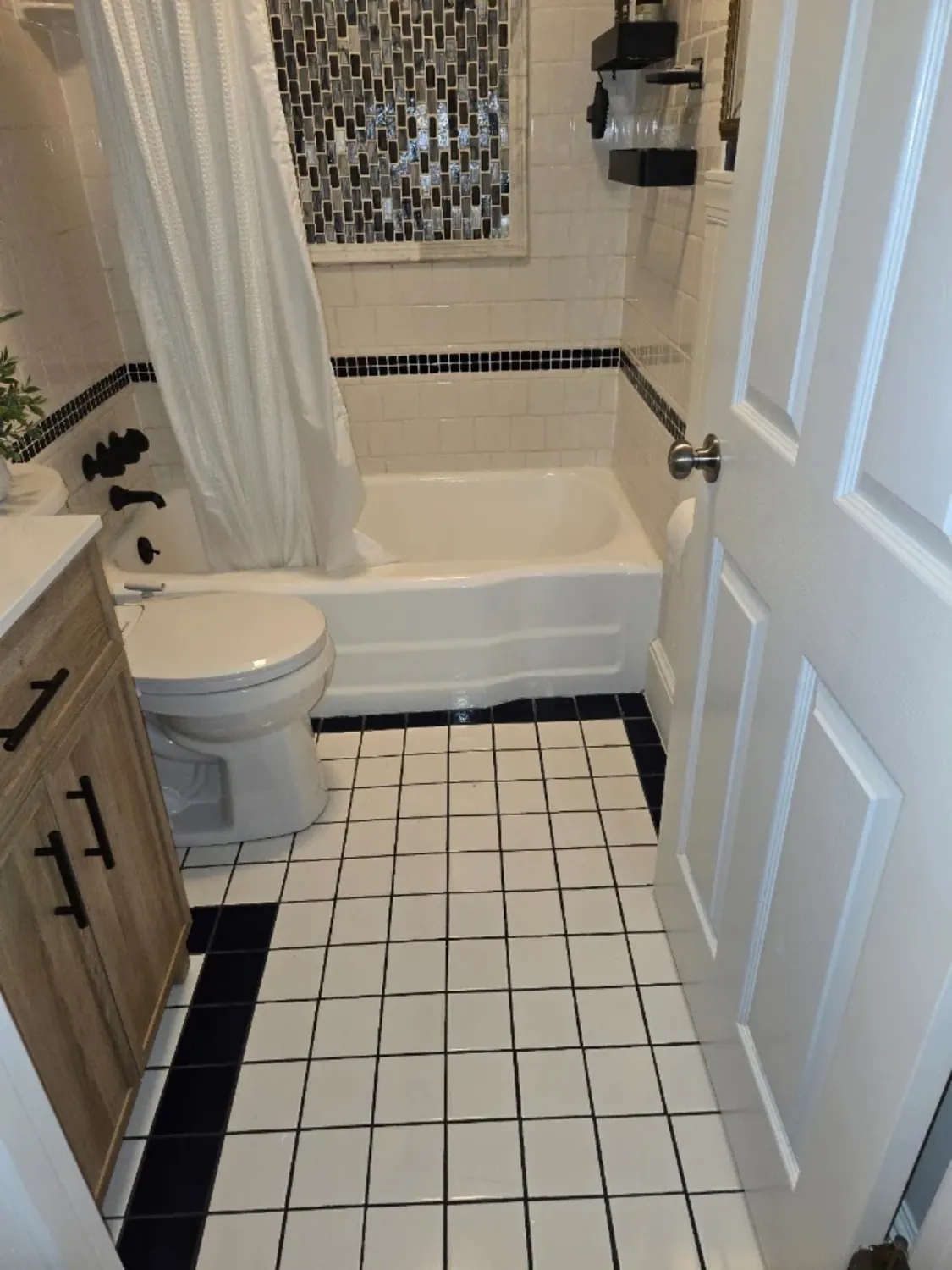 Clean tile and bright white bath and fixtures