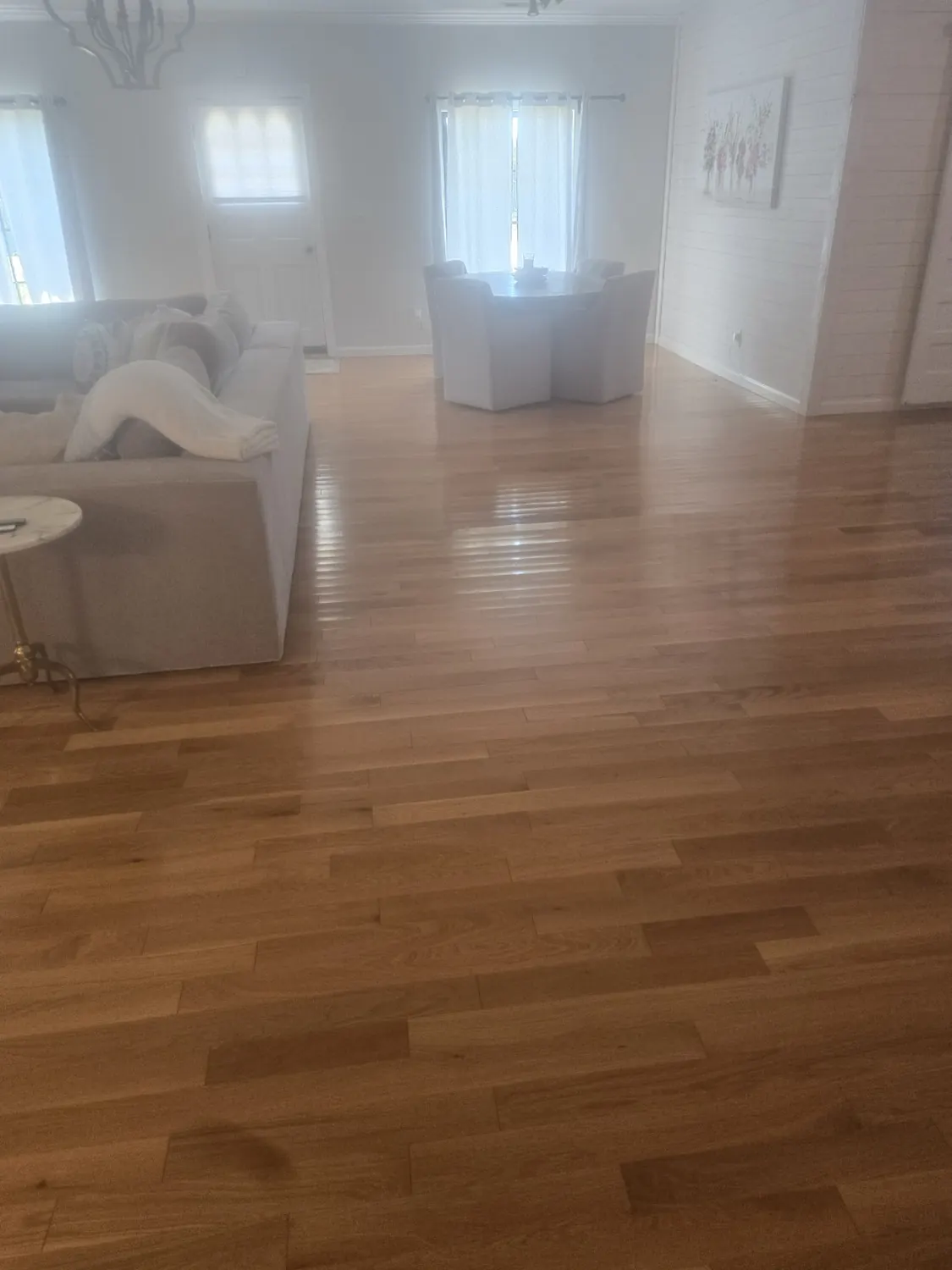 Clean open-plan living room with maintained hardwood floors