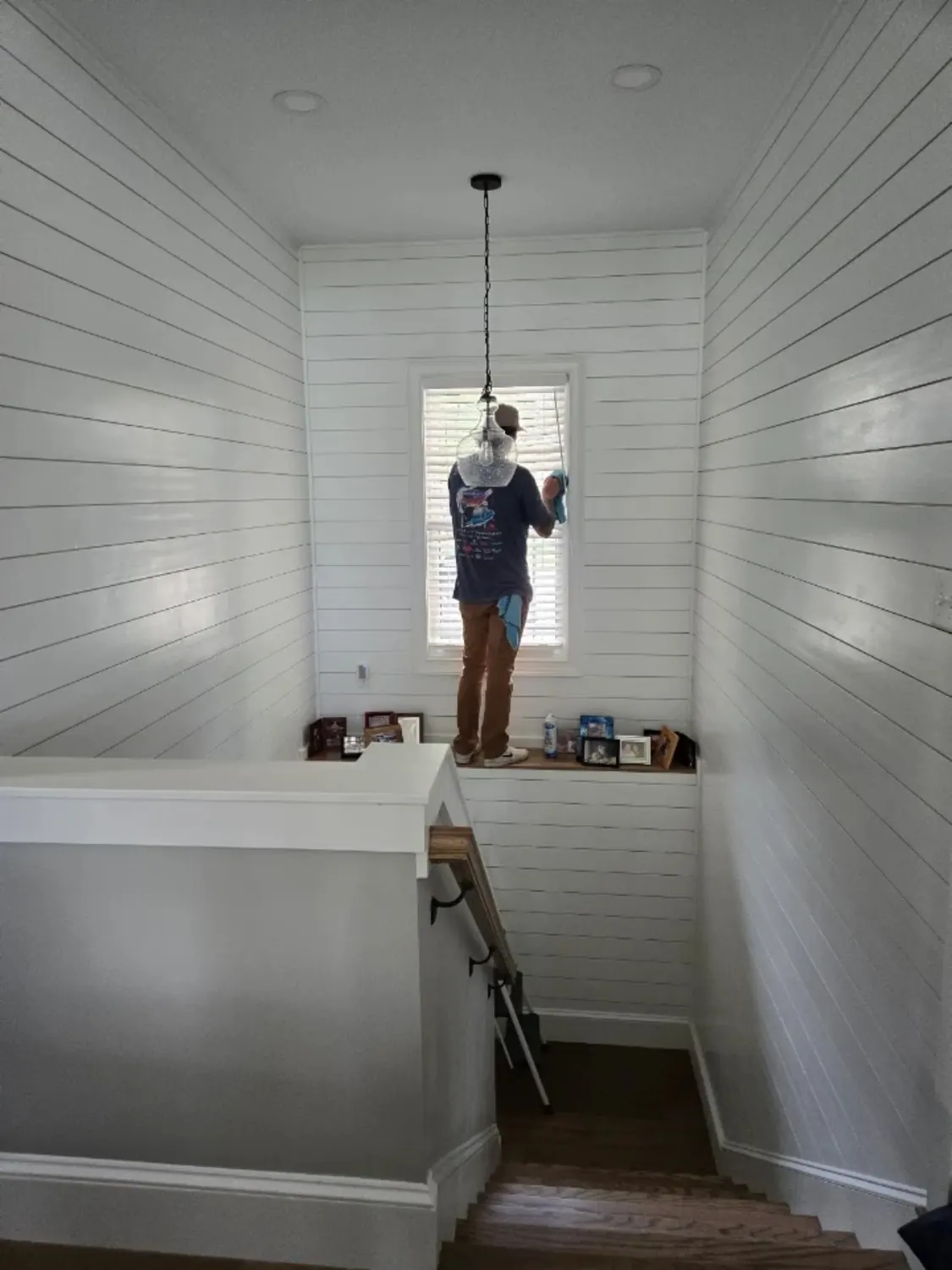 Clean Slate team member carefully wiping window glass